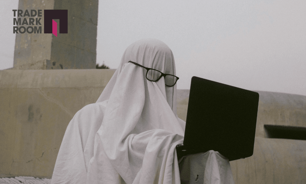 Ghost figure in glasses using a laptop, symbolising parody in trademark law and freedom of expression, with Trademark Room logo in the corner.