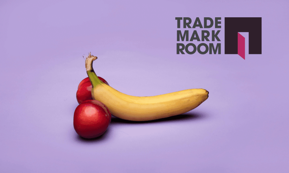 Banana and red apples on a purple background with Trademark Room logo, symbolising provocative branding in sexual trademarks.
