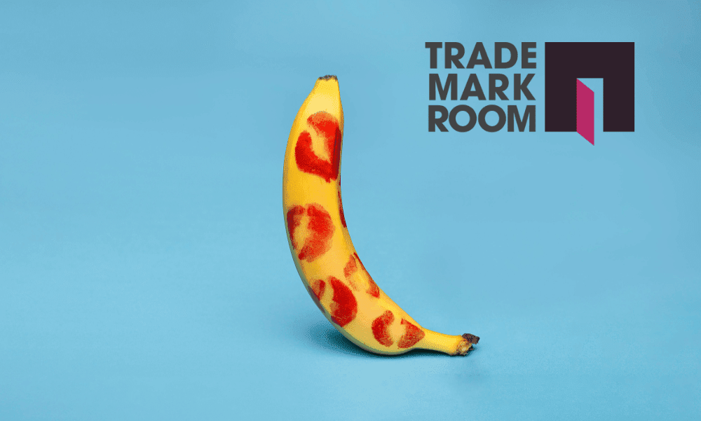 Banana with heart designs on a blue background and Trademark Room logo, symbolising provocative branding in the context of trademark registration.